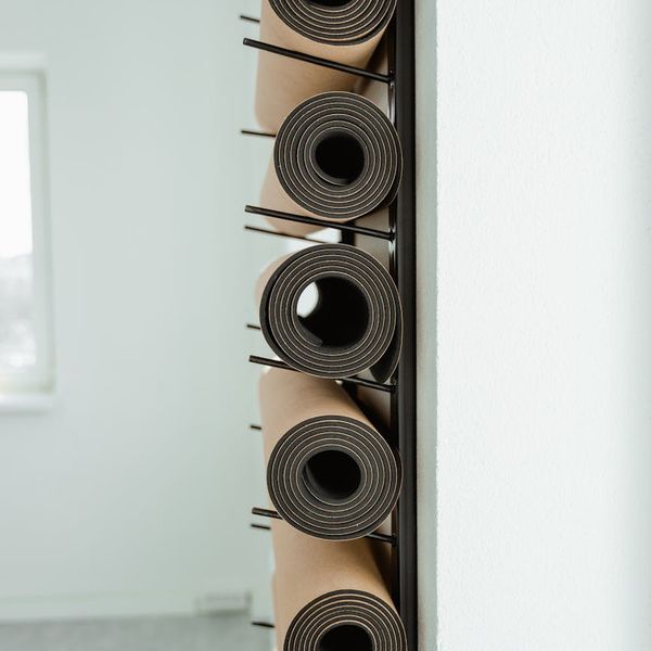 Bright and clean yoga studio interior with mats rolled out.