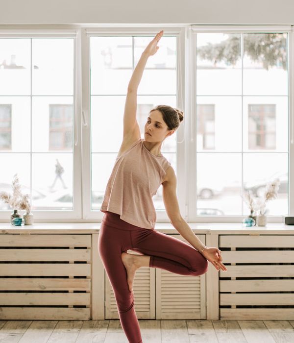 Woman in a graceful yoga pose, embodying balance and calm.
